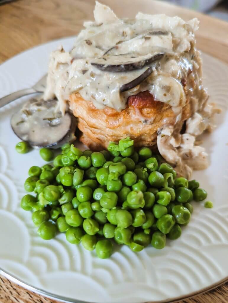 Chicken pie in a puff pastry shell with peas