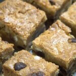 Sliced chewie blondies next to eachother in a close up.